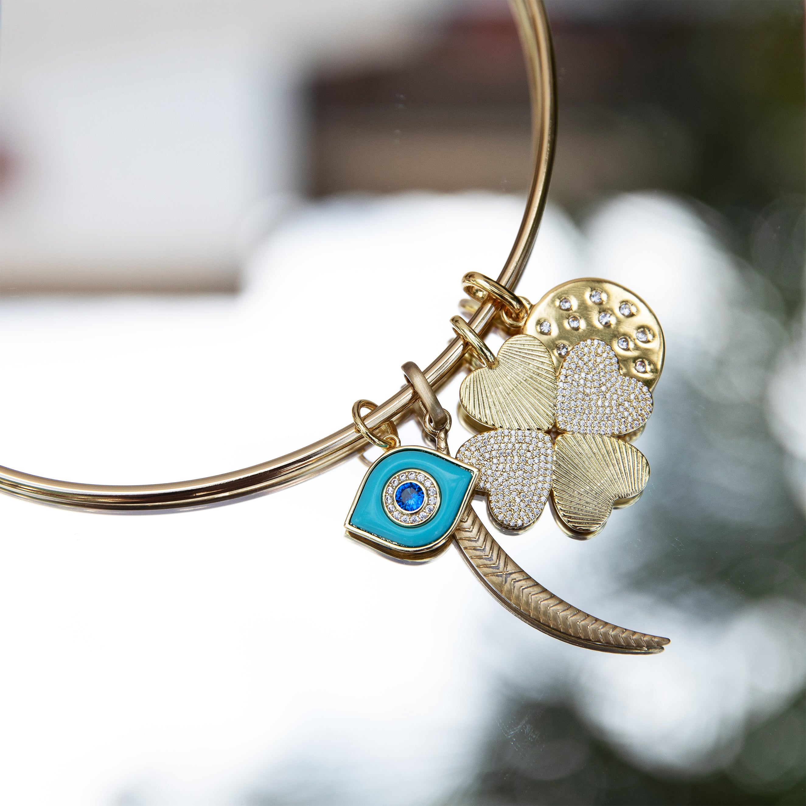 Rounded Thin Choker Adjustable Necklace With Charms
Add a fun twist to your jewelry collection with our Thin Choker Charm Necklace. Featuring a customizable choker design and versatile charms, this unique piece is perfect for any occasion. You'll love the playful and unique touch it adds to any outfit.
14K Yellow Gold Plated
Moon Charm: 2.0" Long X 0.18" Wide
Eye Charm: 0.77" Long X 0.54" Wide
Clover Charm: 1.12" Wide
CZ Disc Charm: 0.80" Wide
11" Around the neck
2.55MM Thick