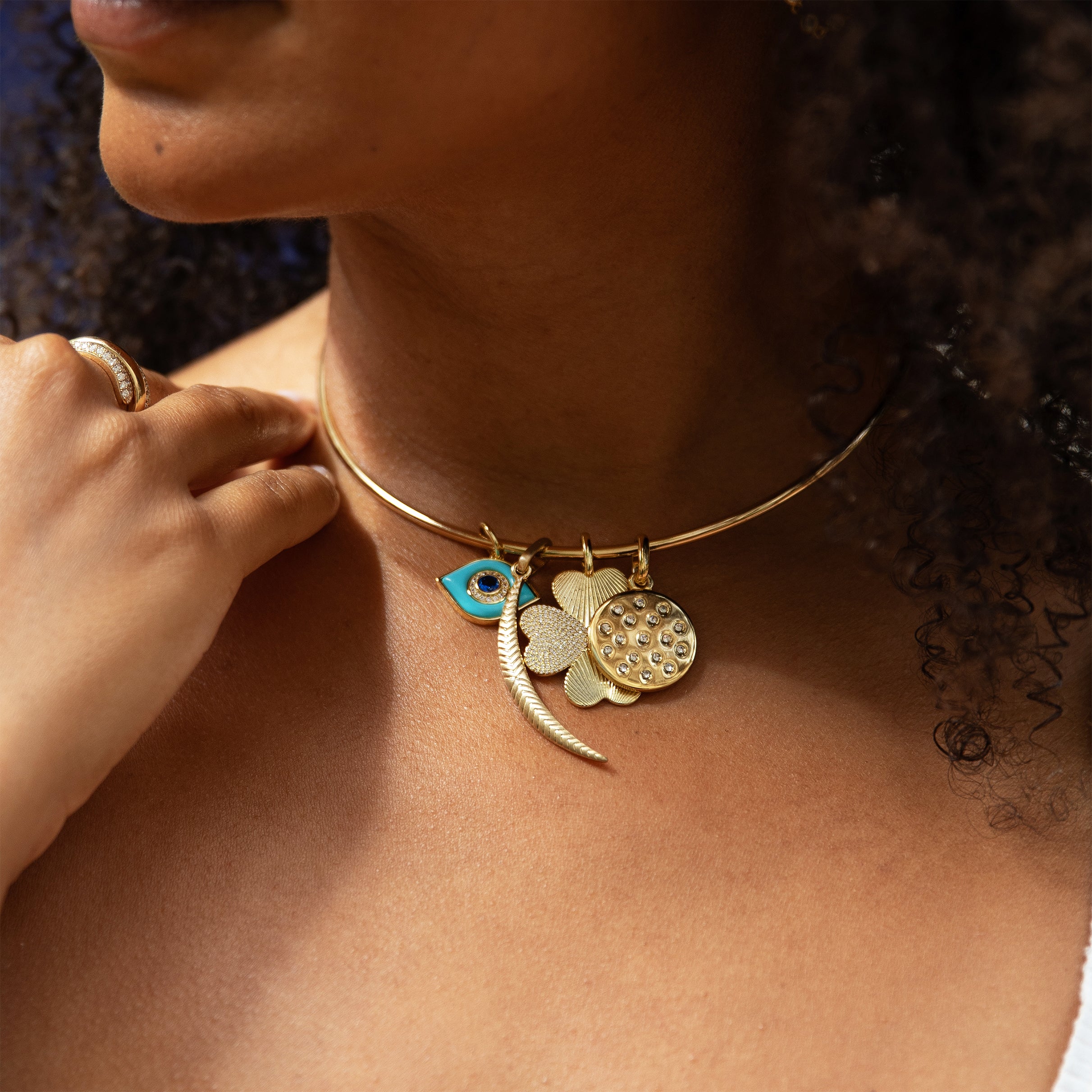 Rounded Thin Choker Adjustable Necklace With Charms
Add a fun twist to your jewelry collection with our Thin Choker Charm Necklace. Featuring a customizable choker design and versatile charms, this unique piece is perfect for any occasion. You'll love the playful and unique touch it adds to any outfit.
14K Yellow Gold Plated
Moon Charm: 2.0" Long X 0.18" Wide
Eye Charm: 0.77" Long X 0.54" Wide
Clover Charm: 1.12" Wide
CZ Disc Charm: 0.80" Wide
11" Around the neck
2.55MM Thick