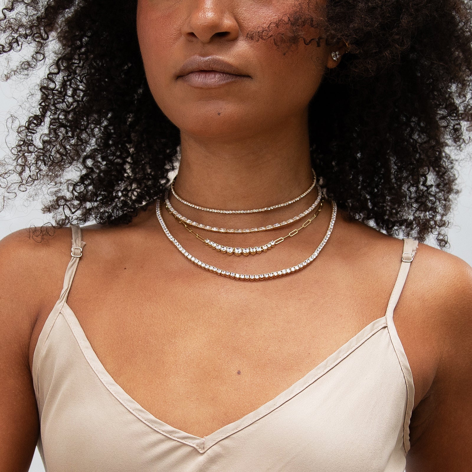 Graduated Tennis on a Chain Necklace
A flawless blend of a tennis necklace and a chain, this piece is as stunning as it is versatile. Our newest Tennis Necklace is already a must-have for layering, but with graduated simulated diamonds, it exudes effortless luxury.
18K Yellow Gold Plated
16-19" Adjustable Length