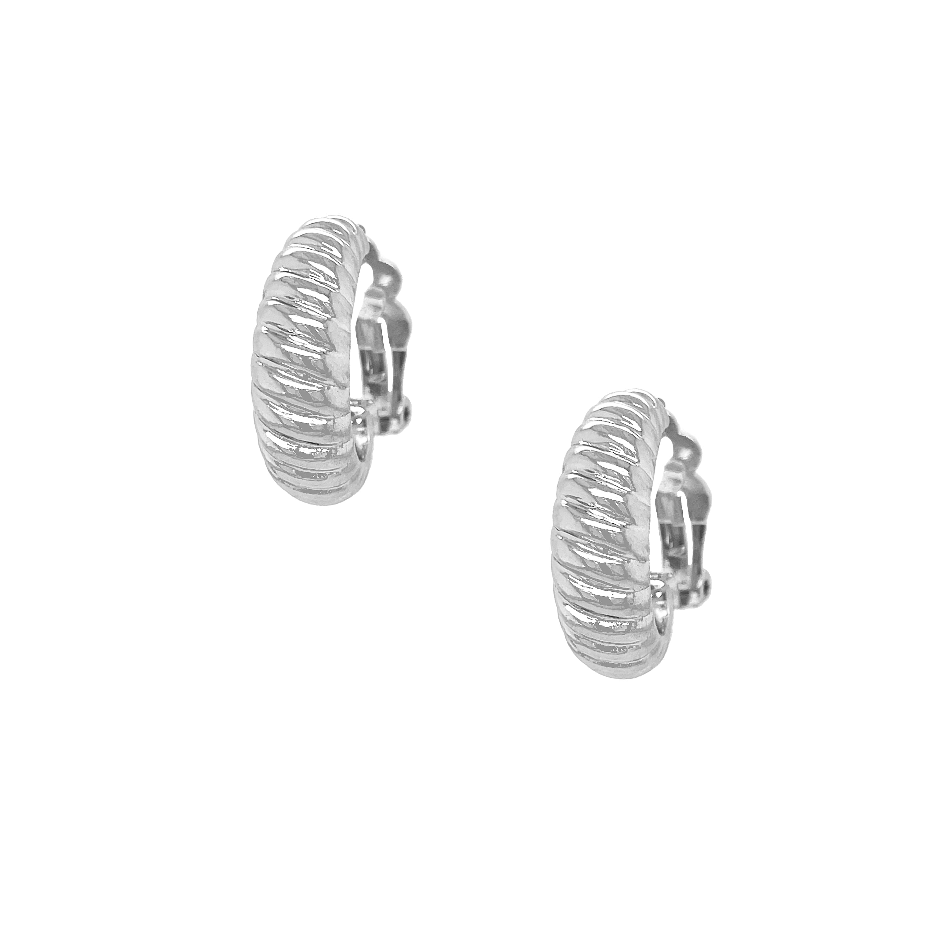 Twist Hoop Clip-On Earrings
A timeless essential with a subtle statement feel. Plated in white gold, these hoops feature a soft twisted ribbed texture that adds dimension and shine. The silhouette sits comfortably on the ear, making them an easy everyday staple that pairs effortlessly with studs, hoops, or statement pieces.
White Gold Plated
1" Long X 0.33" Wide
