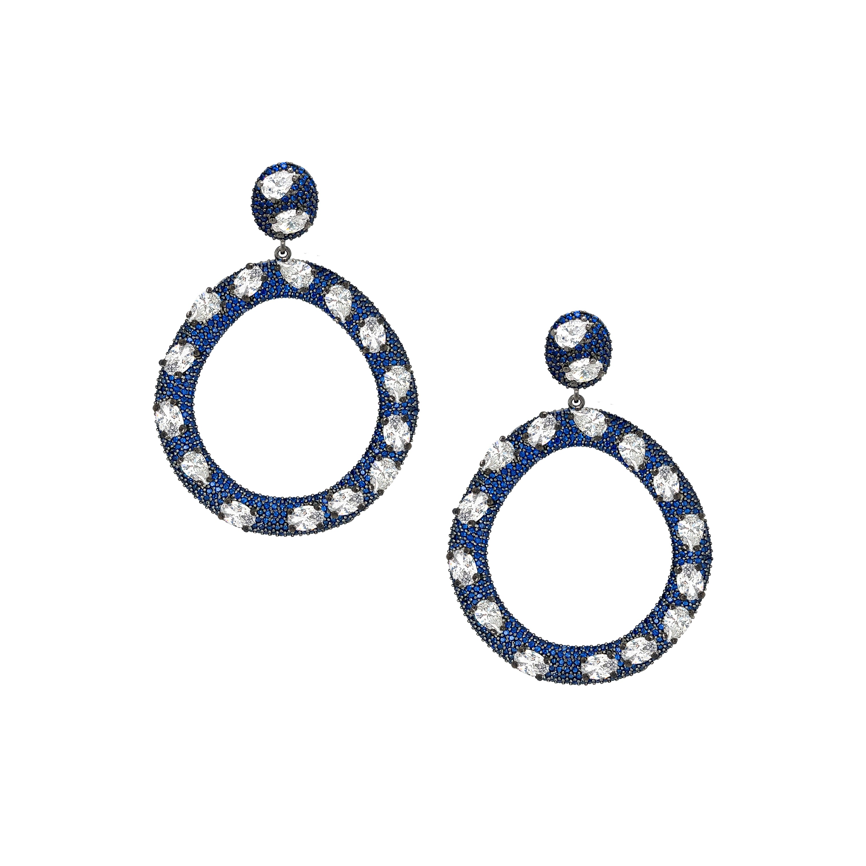 Defined by vibrant blue and white crystals, these open circle drop earrings offer a refined balance of color and brilliance. Elegant yet striking, they are designed to elevate every look with effortless sophistication.