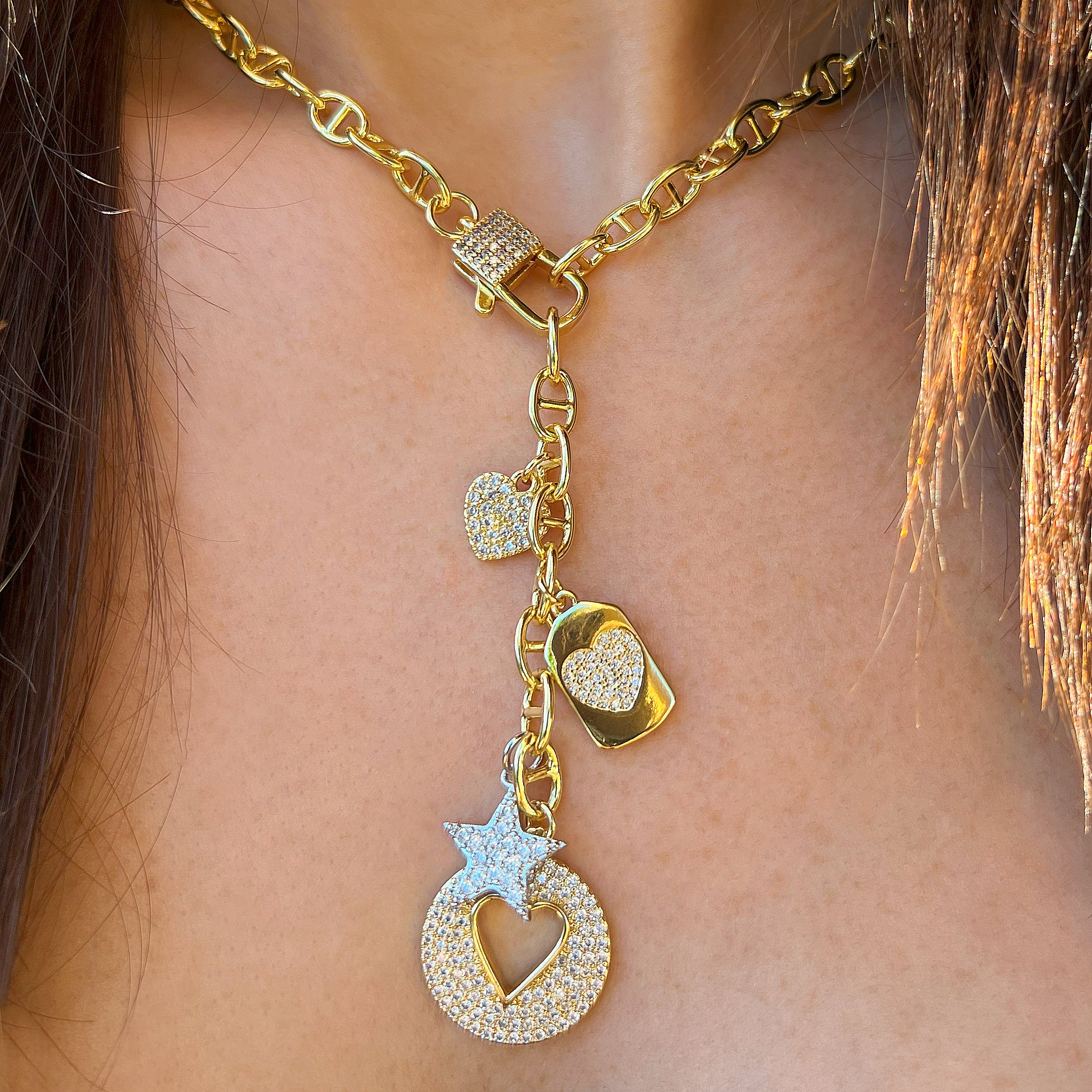 Multi Heart & Star Charm Mariner Link Lariat Drop Necklace
Elevate your style with our pre-made multi charm necklace. Featuring delicate multi heart and star charms on a mariner link lariat design, this necklace exudes luxury and sophistication. You can add your own charms too! Embrace this trend and make a statement with this versatile & chic necklace.
Yellow Gold Plated
17" Length
3" Lariat Drop
Mariner Links: 0.30" Long X 0.23" Wide