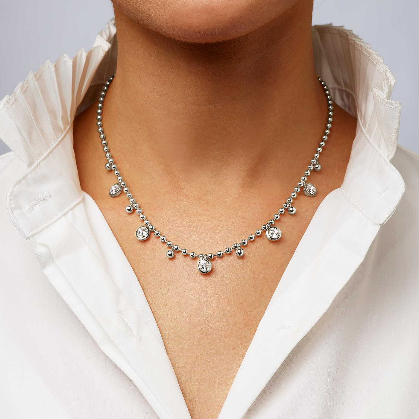 Dangling Bezel Ball Chain Necklace
14K White Gold Plated
Adjustable- Can be worn 16.5-20.5"
5 Bezel-set High Intensity 6 mm CZ, or 0.75 Ct Equivalent
3.3 mm Ball Chain
12mm x 6mm Lobster Trigger Clasp