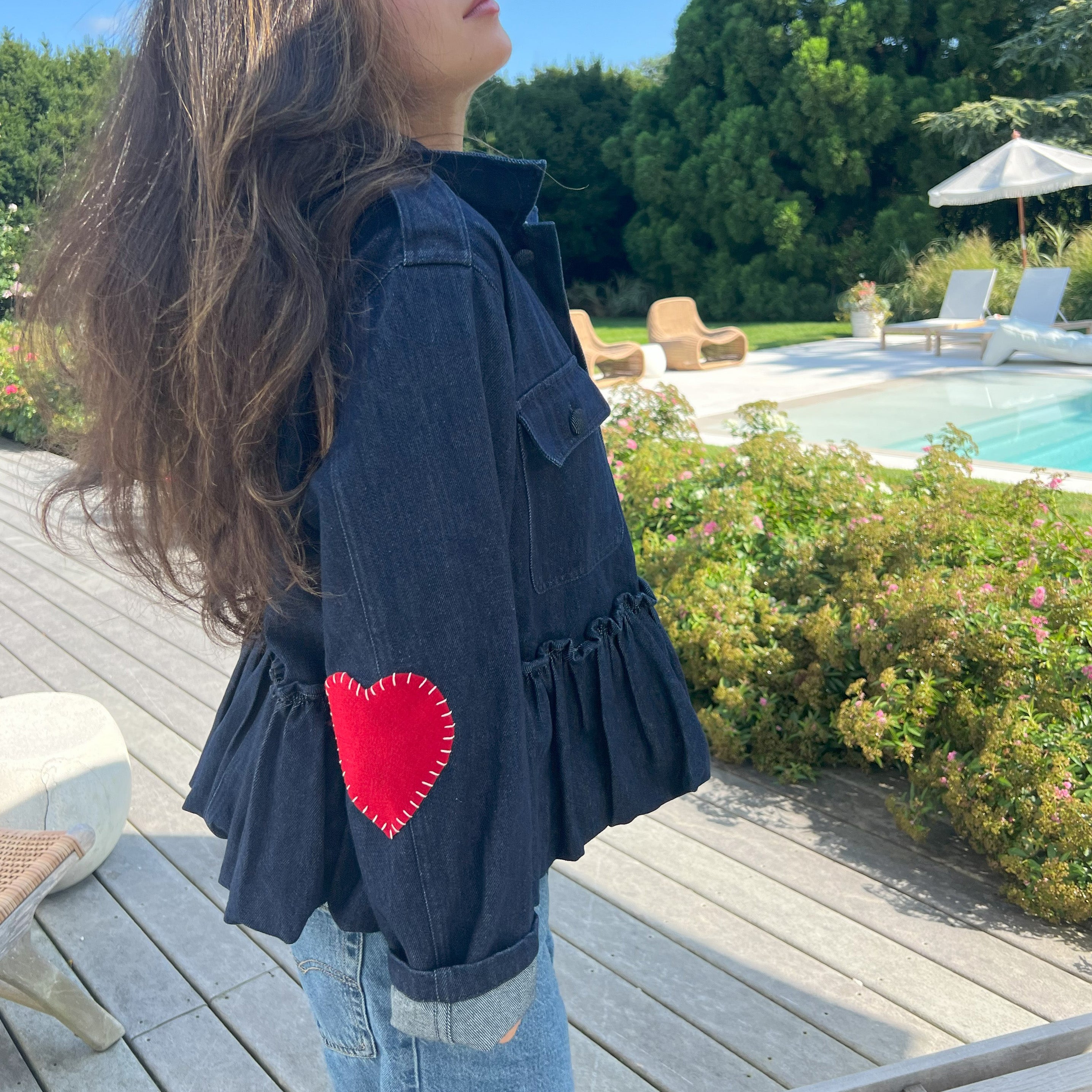 Denim Ruffled Heart Detail Jacket  Looking for a denim jacket that will show off your playful side? Look no further than our Denim Ruffled Jacket! Featuring a cute heart detail, this statement jacket is the perfect addition to any outfit.   Red Hearts On Elbows One Size   Designed by Romi Basha.  Due to popular demand, please allow 2-3 weeks for delivery.