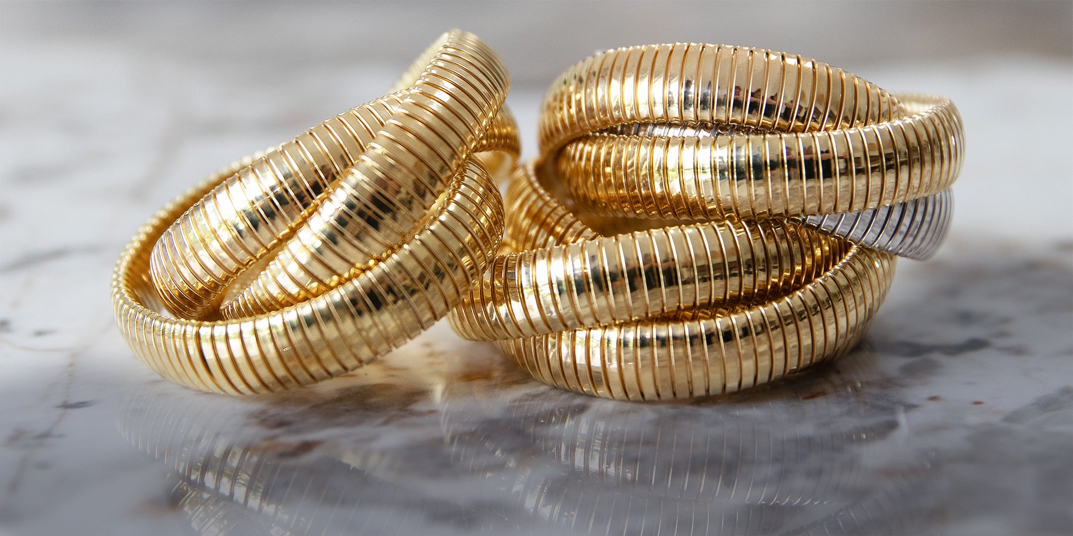 Three triple stranded bracelets on marble background.
