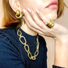 Triple band ring worn with chunky earrings and necklace