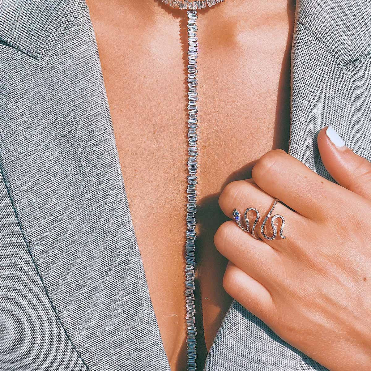 Woman wearing baguette lariat necklace with white gold snake ring