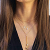 Woman wearing paperclip chain with other layered yellow gold chains