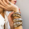 Woman wearing cluster ring with classic triple strand bracelets