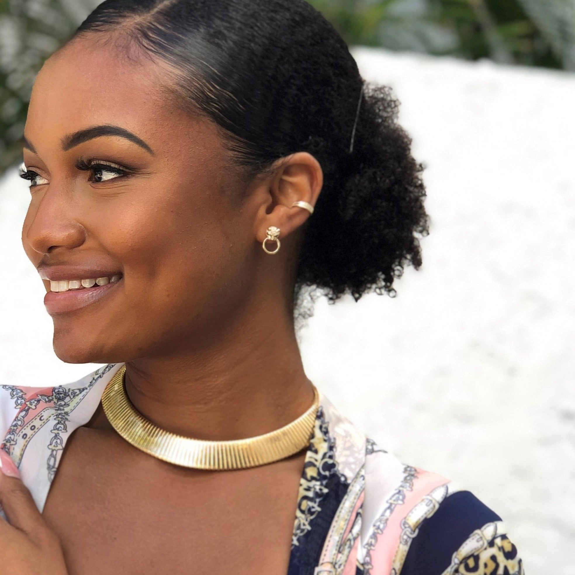 Woman wearing pave ear cuff with yellow gold statement necklace
