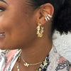 Woman wearing pave ear cuff with yellow gold hoops
