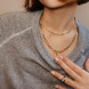 Woman wearing layered rectangle link necklaces