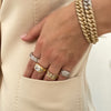 Diamond link bracelets and white and yellow ring stack.