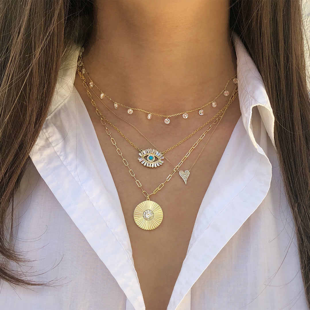 Diamond small heart worn with layered yellow gold chain link necklaces