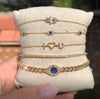 Diamond & sapphire yellow gold bracelet collection on canvas display pillow
