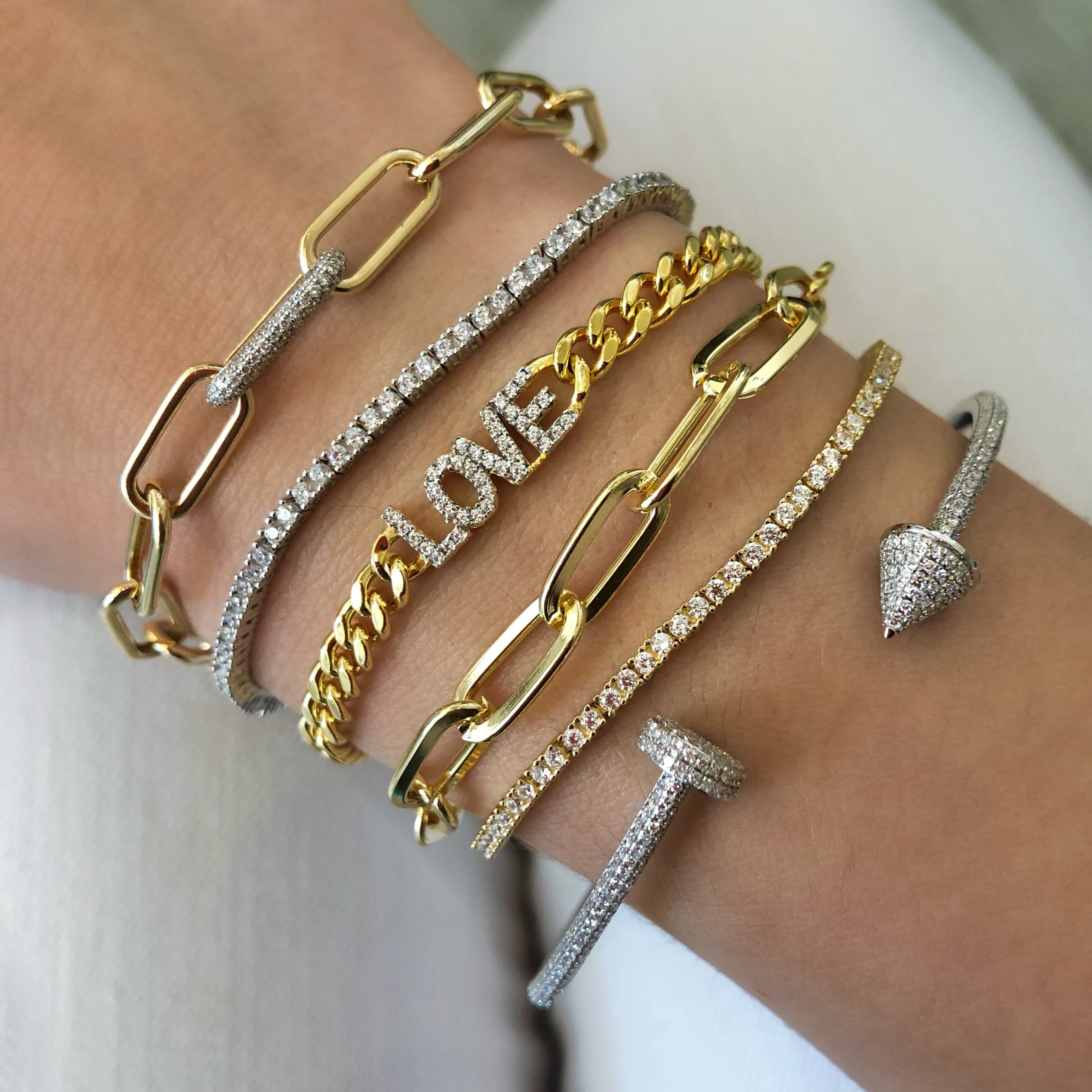 Pave Tennis Bracelet  The tennis bracelet-a classic through the years, updated with a bolo closure.  Prong set CZs over Vermeil.  Simple, Stated, Elegant.  White Gold Plating Over Silver Prong set Cubic Zirconia 0.7" Wide Adjustable to Fit Most Wrists