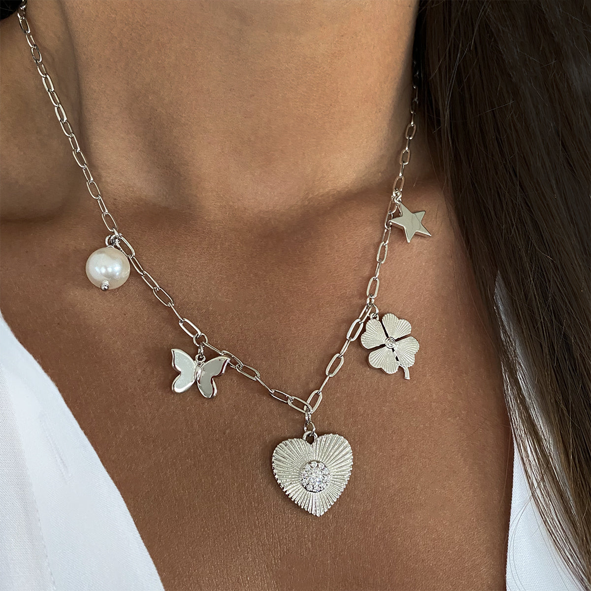 Pearl, Butterfly, CZ Heart, Clover, & Star Charm Chain Necklace 14K White Gold Plated Chain: 16-20" Length Large charm: 0.75" Diameter Small charm: 0.30-0.50" Diameter Pave-set with high intensity CZs