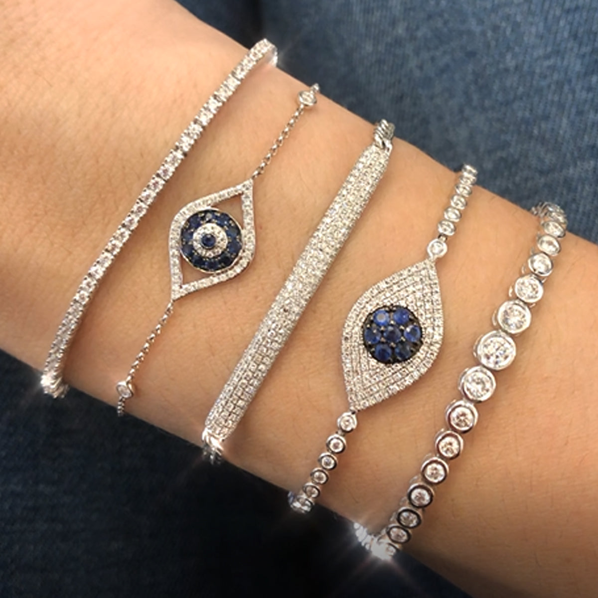 Pave Tennis Bracelet  The tennis bracelet-a classic through the years, updated with a bolo closure.  Prong set CZs over Vermeil.  Simple, Stated, Elegant.  White Gold Plating Over Silver Prong set Cubic Zirconia 0.7" Wide Adjustable to Fit Most Wrists