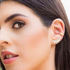 Woman wearing pave ear cuff with diamond crawler earring