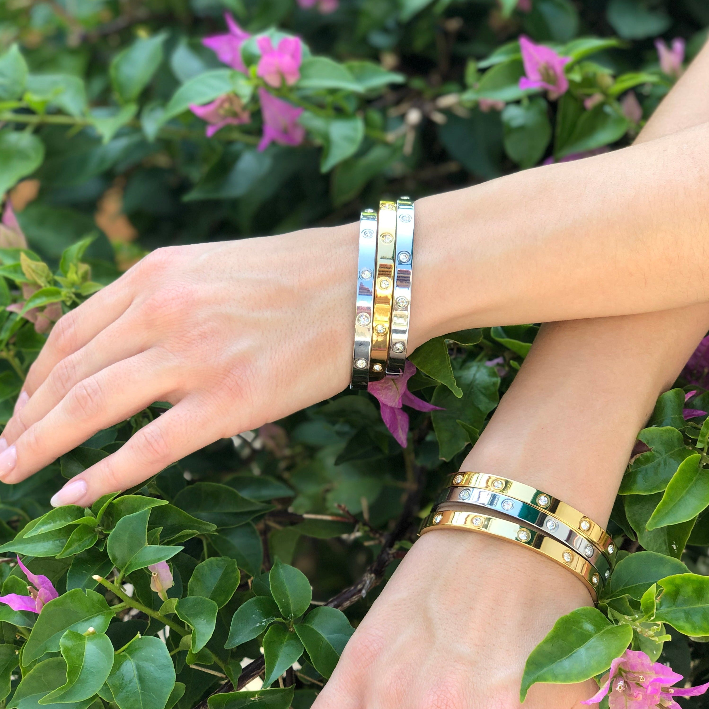 Woman wearing yellow and white gold crystal eternity bangles