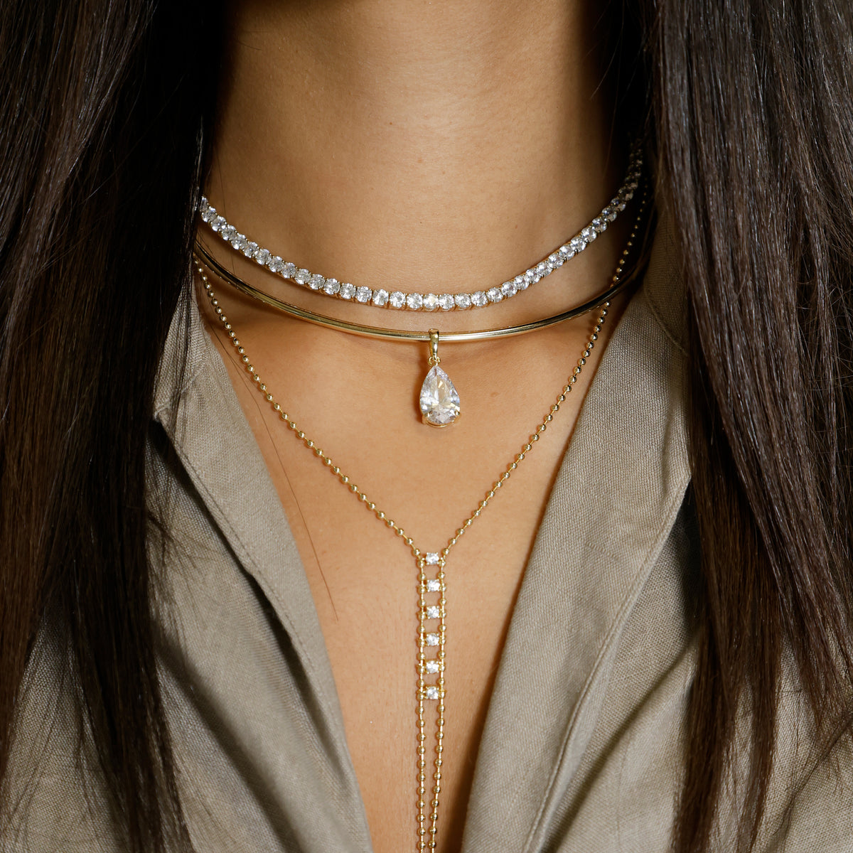 Crystal Pear Drop Choker Necklace

Yellow Gold Plated
Cubic Zirconia
Removable Charm: 1.05" Long X 0.40" Wide