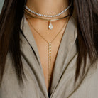 Six Crystals &amp; Ball Strand Lariat Necklace

Yellow Gold Plated Over Silver
Cubic Zirconia
15-19" Length
5" Drop