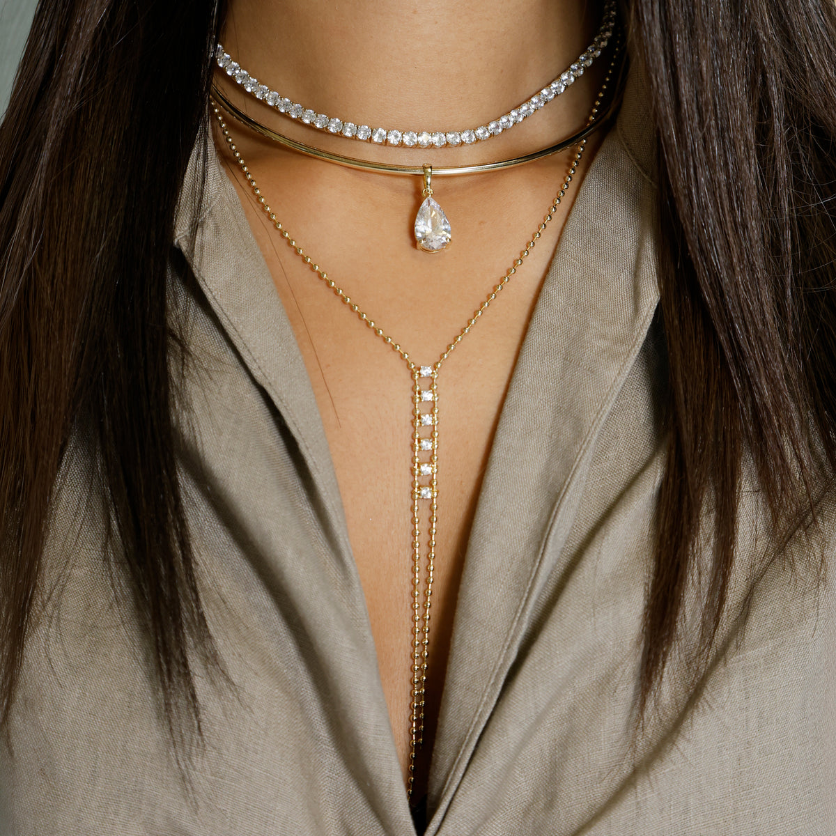 Six Crystals &amp; Ball Strand Lariat Necklace

Yellow Gold Plated Over Silver
Cubic Zirconia
15-19" Length
5" Drop