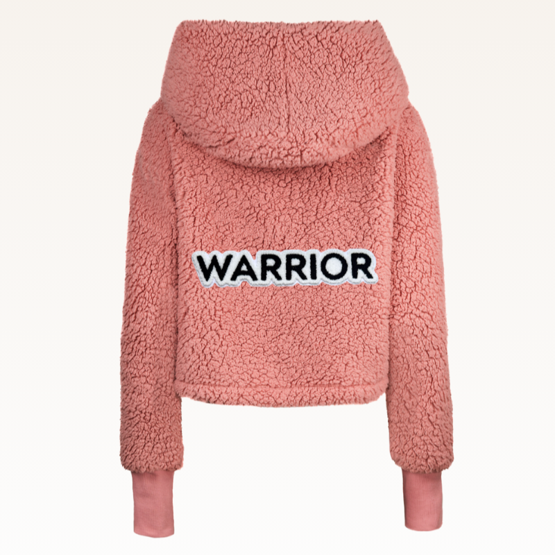 The Warrior Cropped Lounger is more than loungewear—it’s a lifestyle. I designed it in plush sherpa to be worn 24/7, 365 days a year, from couchside to courtside and everywhere in between. For me, it’s a true badge of comfort and strength—there for every moment I choose to thrive.&nbsp;Show here in Romantic Rose.


Product Details &amp; Care Instructions:

Fabrication: 100% Polyester, Sherpa
Features: Sherpa, Hood, Button Front-Closure, Rib Cuffs with Thumbholes
Fit: Relaxed Fit: Generously Cut with Maximum