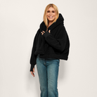The Warrior Cropped Lounger is more than loungewear—it’s a lifestyle. I designed it in plush sherpa to be worn 24/7, 365 days a year, from couchside to courtside and everywhere in between. For me, it’s a true badge of comfort and strength—there for every moment I choose to thrive.&nbsp; Show here in Black.


Product Details &amp; Care Instructions:

Fabrication: 100% Polyester, Sherpa
Features: Sherpa, Hood, Button Front-Closure, Rib Cuffs with Thumbholes
Fit: Relaxed Fit: Generously Cut with Maximum Wearin