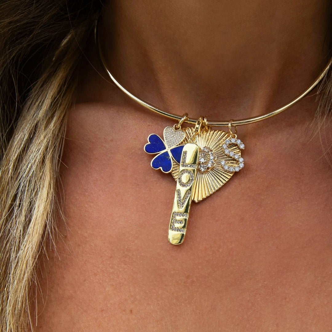 Pave CZ "Love" Charm Pendant

Plated in yellow gold, this vertical bar charm features the word “LOVE” accented with shimmering cubic zirconia stones for a subtle touch of sparkle. Designed with a clasp for easy attachment, it can be added to necklaces, bracelets, or charm holders to personalize your look.

Yellow Gold Plated
2.22" Long X 0.30" Wide