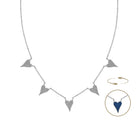 A silver-toned necklace with five pavé-set triangular pendants, shown on a white background with a circular inset detail of one pendant revealing a reversible blue color
