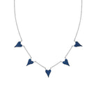 A silver chain necklace featuring five small, pointed heart-shaped charms covered in dark blue stones, displayed against a solid white background.