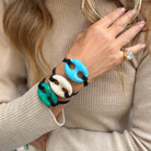 Mariner Link Black Hair Tie And Bracelet

An everyday essential with a polished feel. This Mariner Link Hair Tie adds a stylish touch to any look. Wear it in your hair or slip it onto your wrist as a chic bracelet for effortless style on the go. Available in vibrant colors to complement every look.

Link: 1.5" Long X 1.8" Wide