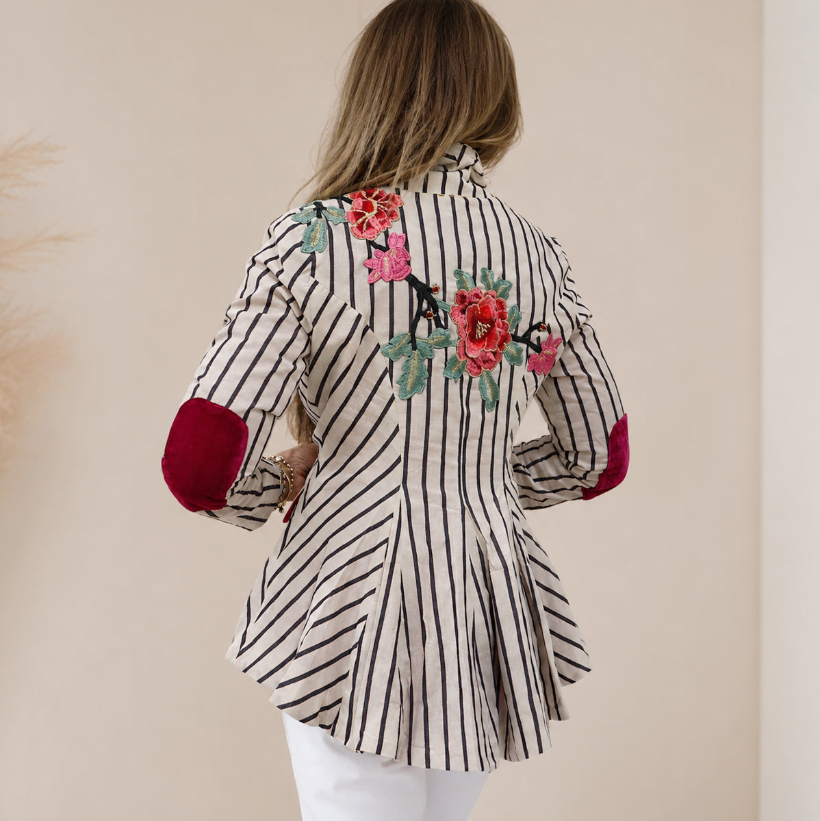 Cream Stripes Floral Blazer

A timeless tailored blazer with an artistic twist. Crafted from breathable 100% cotton and finished with a smooth satin lining, this cream striped blazer is elevated with beautifully embroidered floral appliqués on both the front and back shoulders. Crystal button detailing and classic flap pockets add a polished finish, making it the perfect statement layer to dress up denim or complete a chic occasion look.

100% Cotton
Tailored Fit