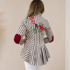 Cream Stripes Floral Blazer

A timeless tailored blazer with an artistic twist. Crafted from breathable 100% cotton and finished with a smooth satin lining, this cream striped blazer is elevated with beautifully embroidered floral appliqués on both the front and back shoulders. Crystal button detailing and classic flap pockets add a polished finish, making it the perfect statement layer to dress up denim or complete a chic occasion look.

100% Cotton
Tailored Fit
