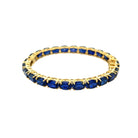 Oval Blue Sapphire &amp; White Topaz Tennis Bangle Bracelet

Yellow Gold Plated Over Silver&nbsp;
Lab Blue Sapphire
0.23" Wide