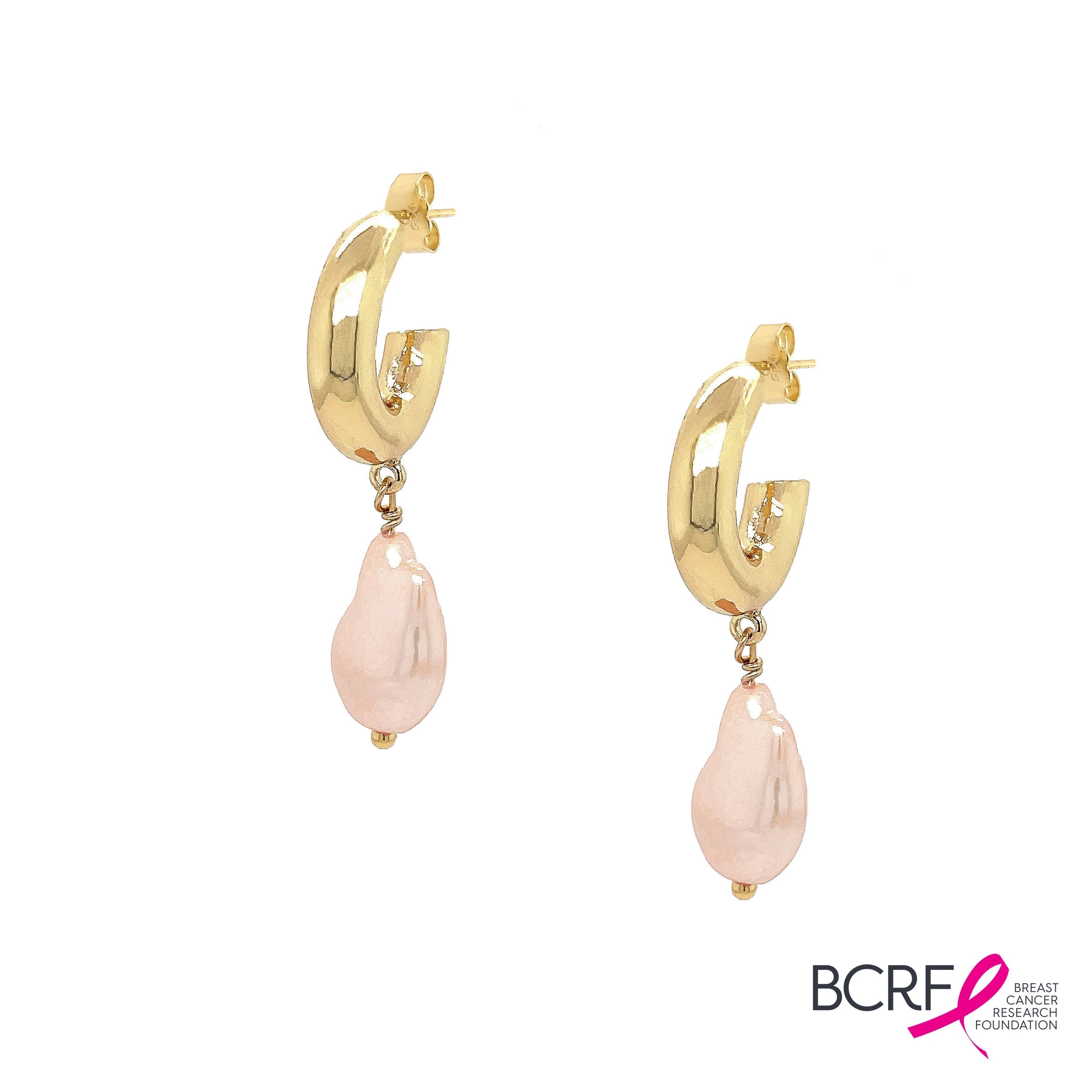 These exquisite hoops feature a stunning light pink pearl elegantly set in your choice of yellow or white gold plating, embodying the essence of elegance and hope. These gorgeous earrings perfectly complement any ensemble, making them a versatile addition to your jewelry collection. Pair them effortlessly with other jewels and stay in vogue while making a meaningful impact.  Pink Pearl Drop on Small Hoop Pieced Earrings  Yellow or White Gold Plating 1.75" Long X 0.42" Wide