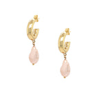 These exquisite hoops feature a stunning light pink pearl elegantly set in your choice of yellow or white gold plating, embodying the essence of elegance and hope. These gorgeous earrings perfectly complement any ensemble, making them a versatile addition to your jewelry collection. Pair them effortlessly with other jewels and stay in vogue while making a meaningful impact.  Pink Pearl Drop on Small Hoop Pieced Earrings  Yellow or White Gold Plating Faux Light Pink Pearl 1.75" Long X 0.42" Wide