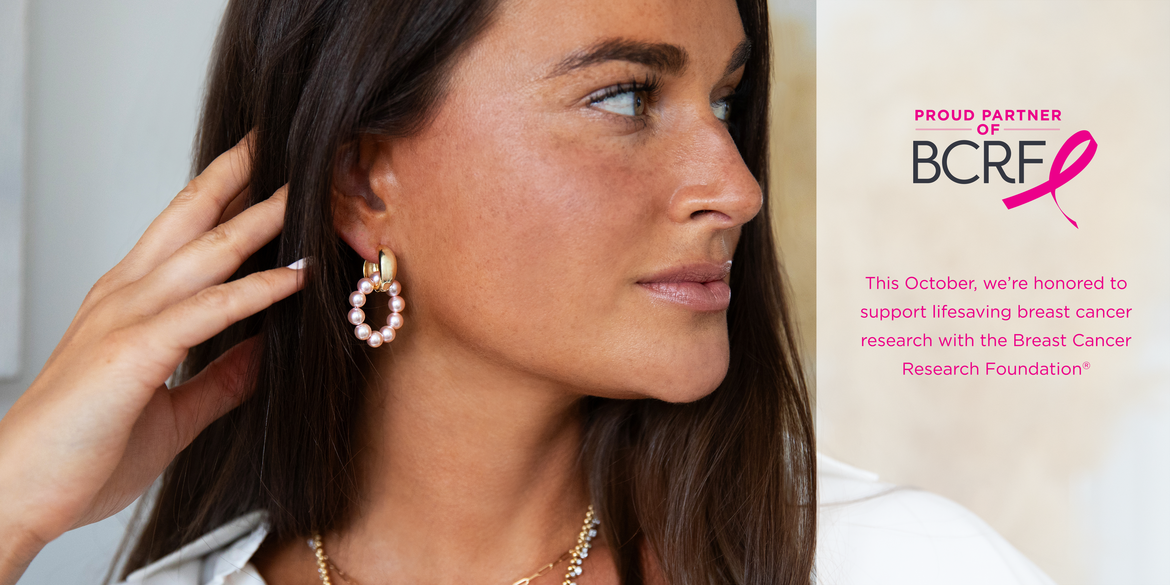 Woman wearing gold hoop earrings with a Breast Cancer Research Foundation (BCRF) logo in the corner.