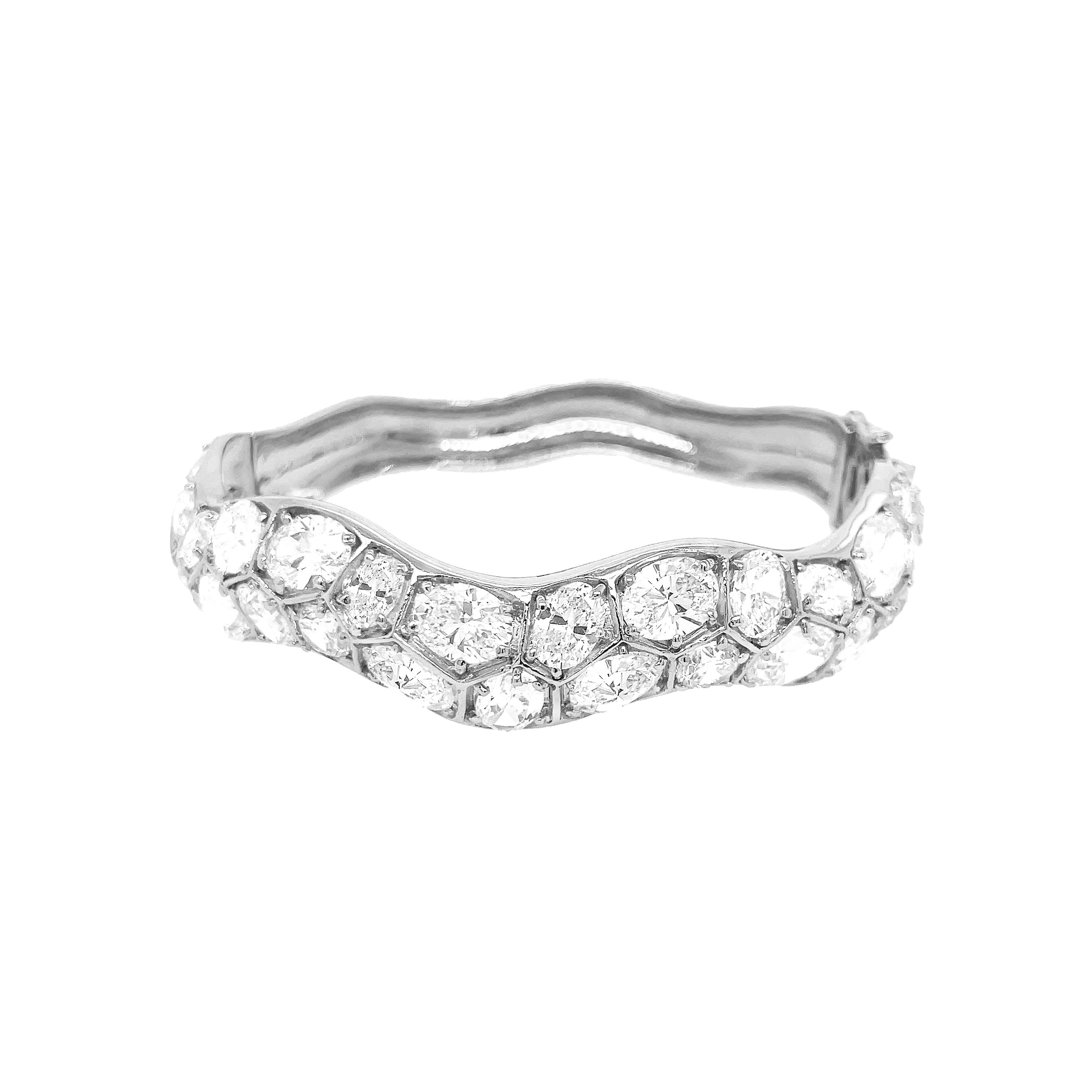 <p>CZ Cluster Wave Bangle Bracelet</p> <ul> <li>White Gold Plated</li> <li>0.75" Wide</li> </ul>