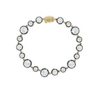 Gold bracelet with round diamonds on a white background