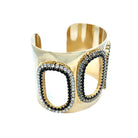 Black &amp; Clear Oval Cutout Cuff Bracelet

Yellow Gold Plated
1.94" Wide