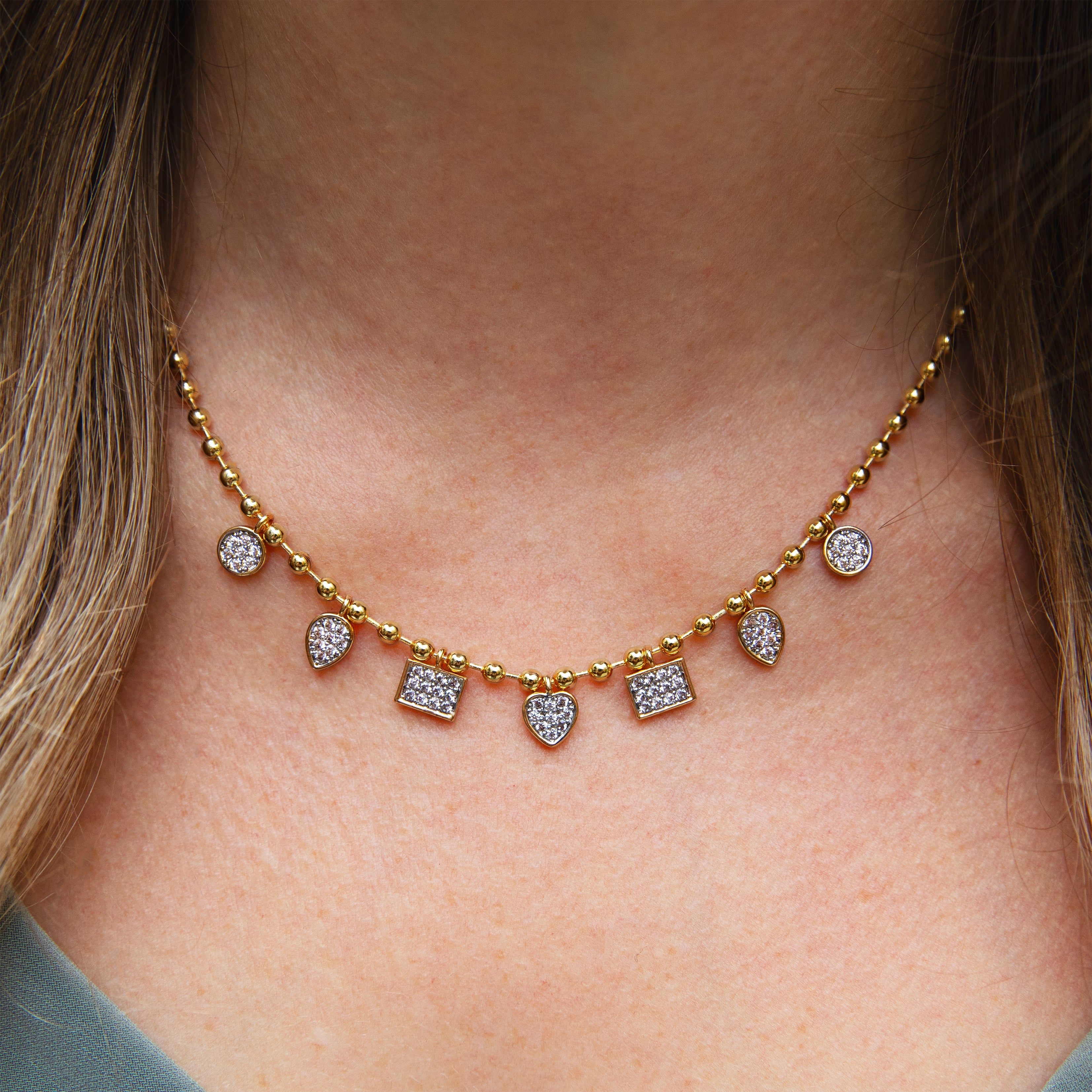 Pave Charm Ball Chain Necklace

14K Yellow Gold Plated
Adjustable- Can be worn 16.5-21"

6.5mm CZ Pave Disc Charms &nbsp;
8mm x 6mm CZ Pave Pear &amp; Square Charms&nbsp;
3.3 mm Ball Chain&nbsp;
12mm x 6mm Lobster Trigger Clasp