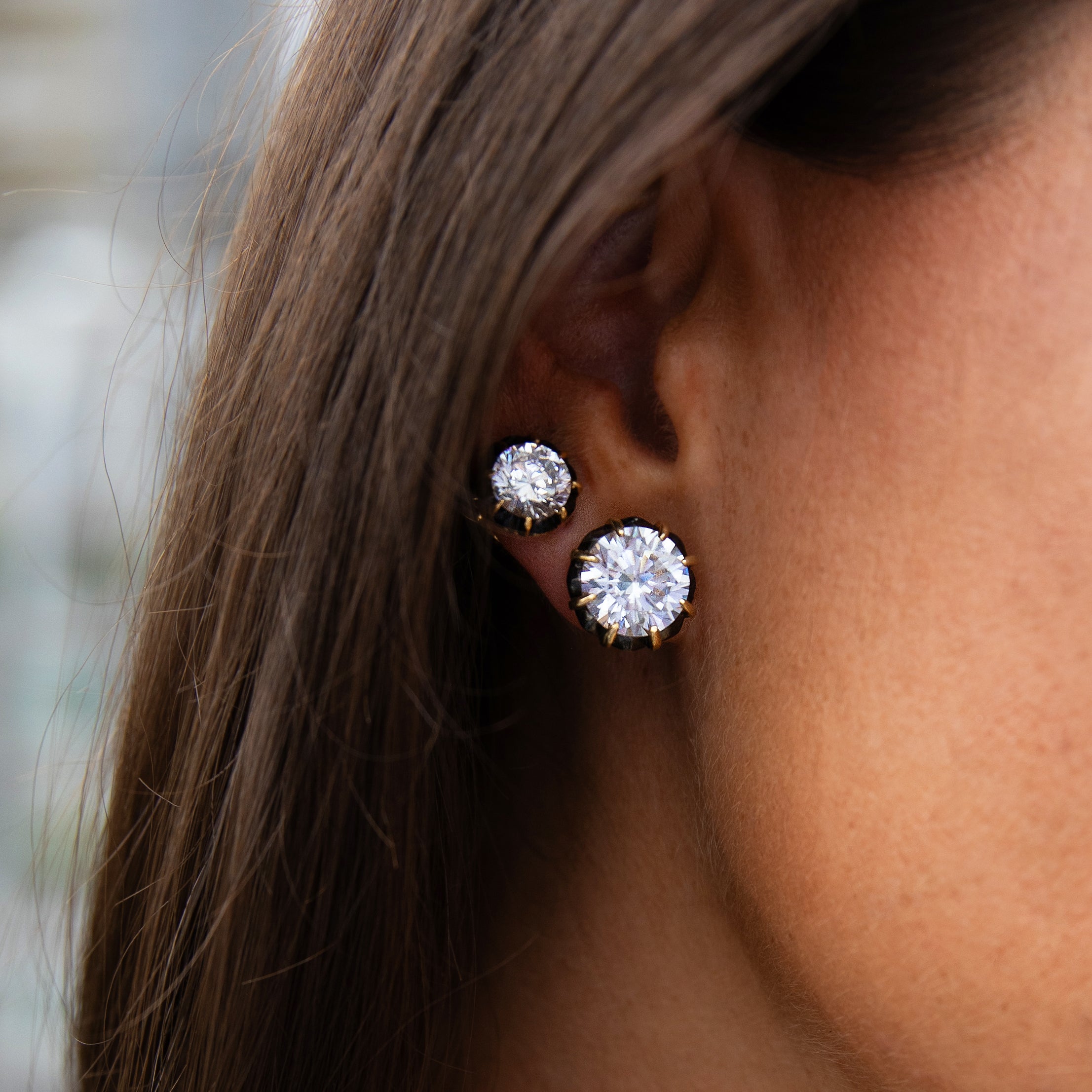 Crystal Stud Pierced Earrings

Oxidized &amp; Yellow Gold Plated
10MM Stud
0.52" Wide