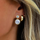 Double Drop Bezel Pierced Earrings

These Double Drop Bezel Pierced Earrings embody refined minimalism with their dual-tiered design and polished bezel settings. Each earring features a graceful descending silhouette that catches light beautifully, making them an ideal choice for both everyday wear and special occasions. The geometric precision and understated elegance ensure these pieces complement any wardrobe while maintaining an air of quiet sophistication. A timeless investment in understated luxury.

