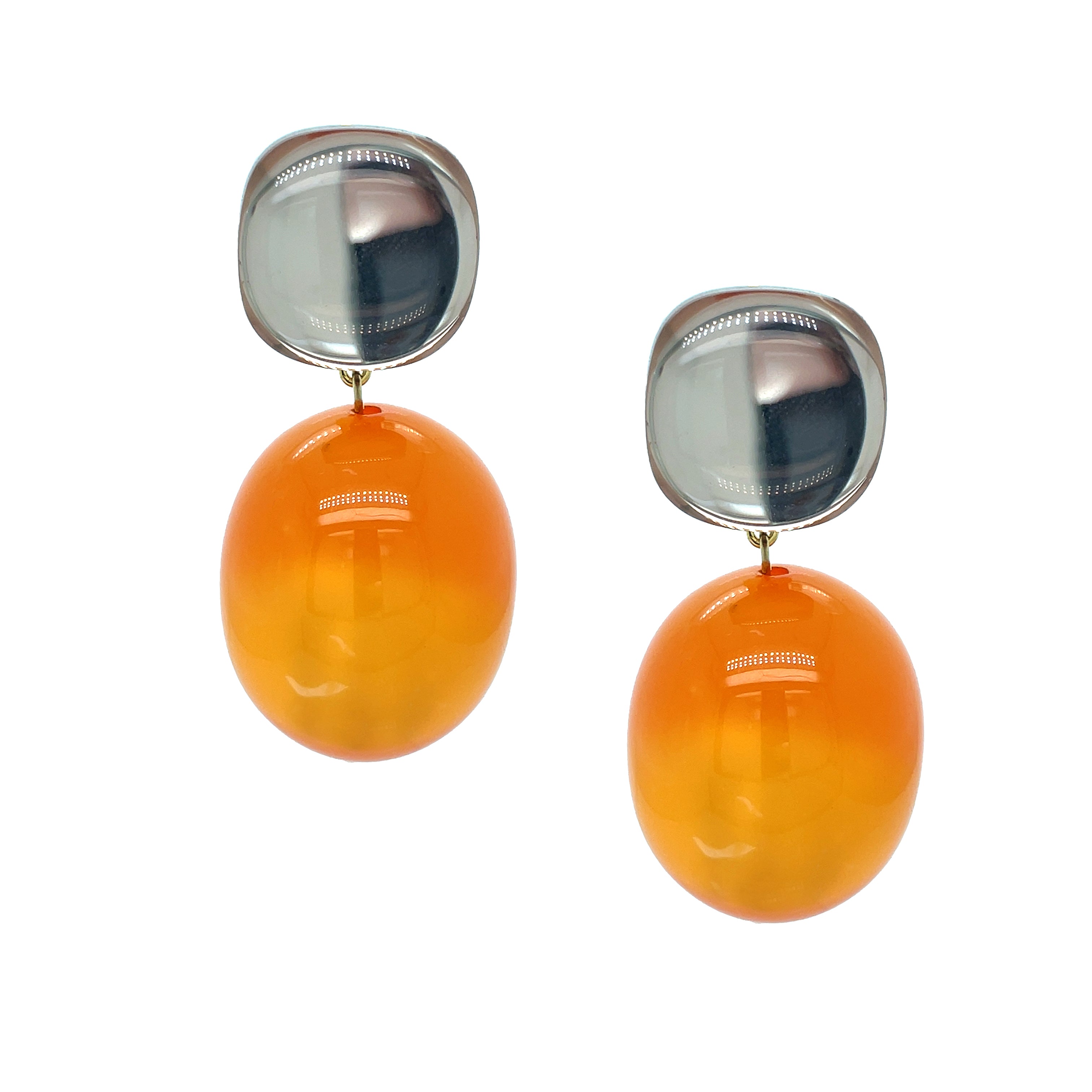 Pair of earrings with orange oval stones and silver tops on a white background