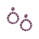 These open circle pierced earrings feature vibrant pink crystals that add a bold, playful pop of color. Lightweight and easy to wear, they bring instant glamour to any look, day or night.