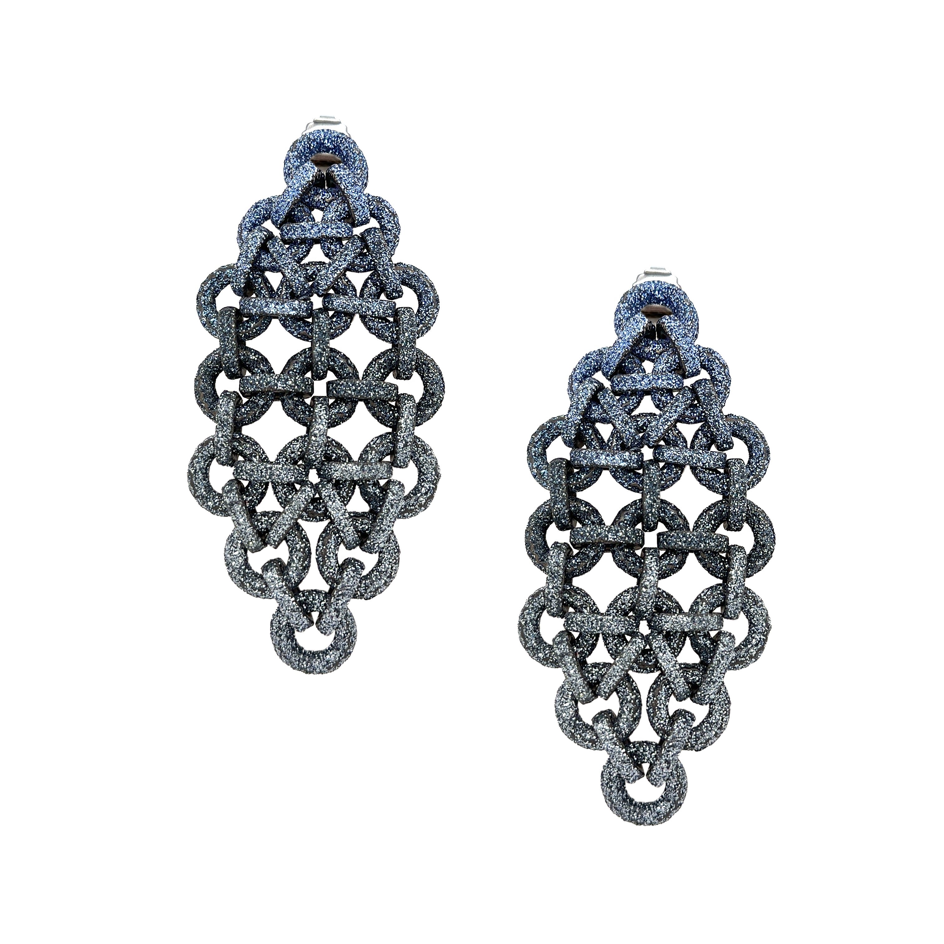 A pair of large, ornate dangle earrings with a textured, dark metallic finish, featuring an intricate openwork geometric pattern of linked rings and loops, shown on a plain white background.