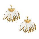 A pair of gold and white feather dangle earrings on a solid white background.