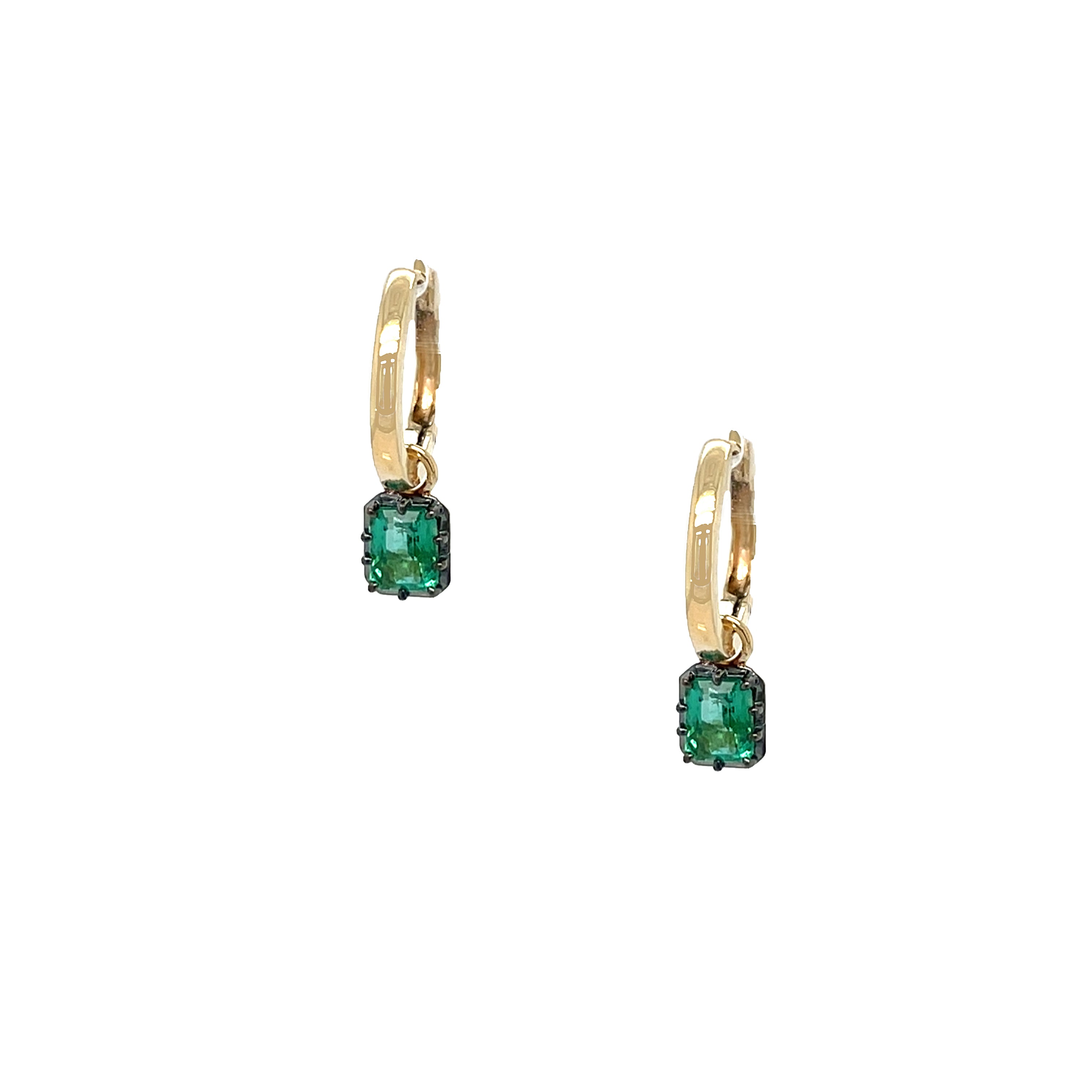 Gold earrings with green gemstones on a white background